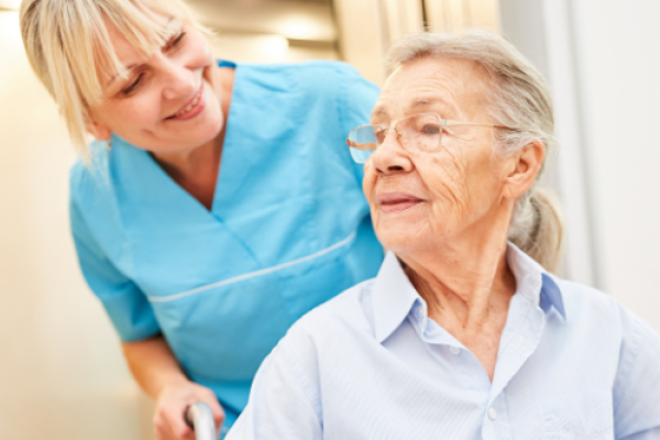 Nurse assisting an older woman